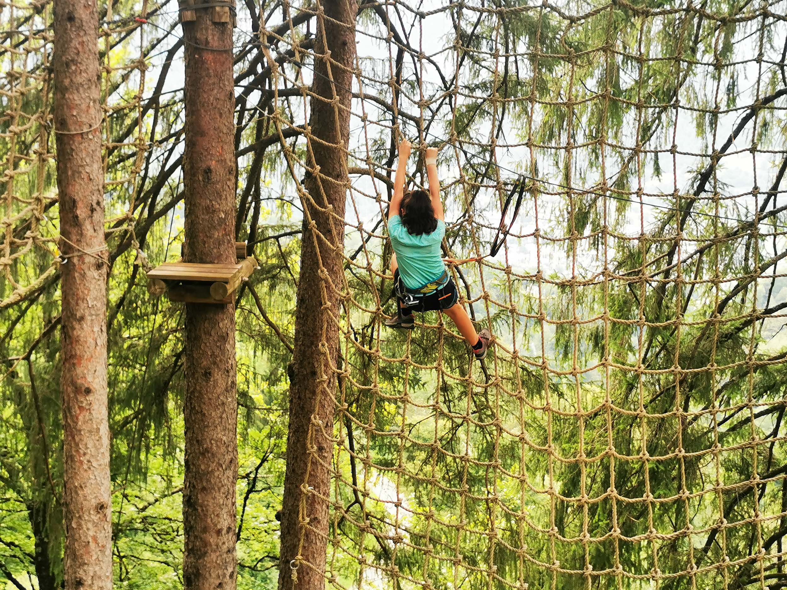 Tree climbing at La Foret Suspendue des Eaux-Bonnes, young girl climbing on a web - &copy; C. Bador